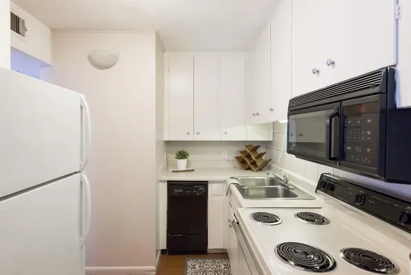 a kitchen with a stove and a refrigerator