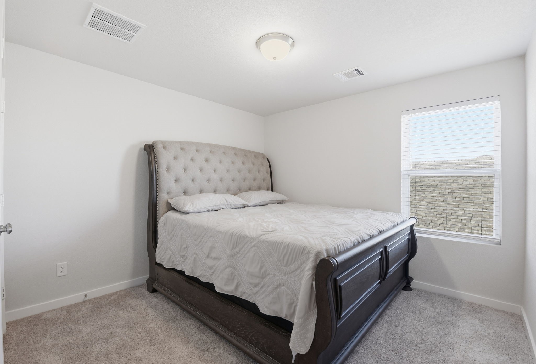 18623 Frost Ridge Drive Crosby, TX 77532 - Photo 35 of 40 a bed sitting in a bedroom next to a window