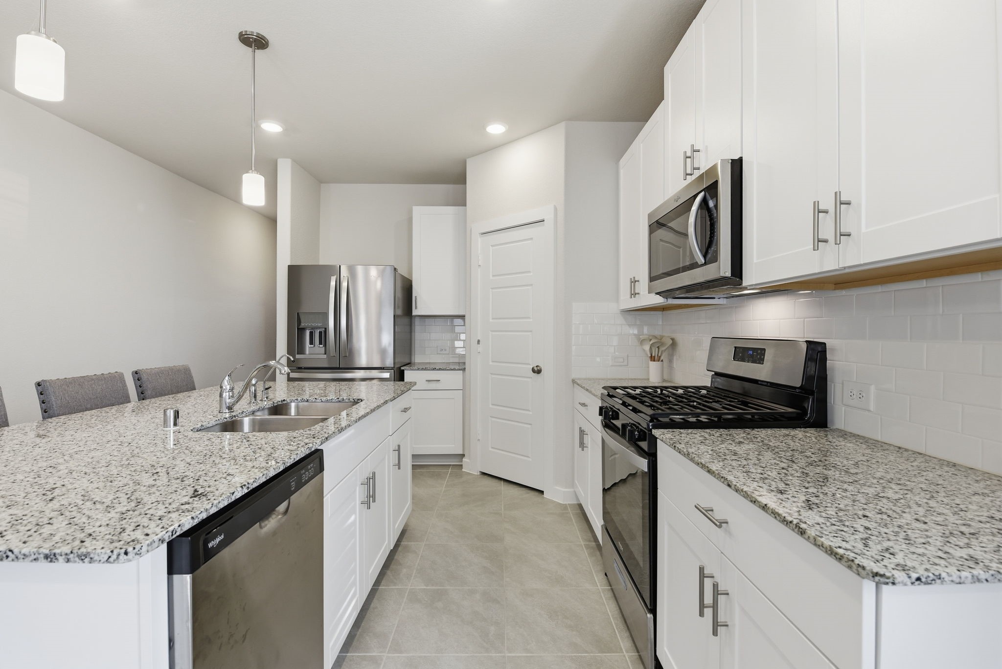 18623 Frost Ridge Drive Crosby, TX 77532 - Photo 5 of 40 a kitchen with stainless steel appliances granite countertop a sink stove and cabinets
