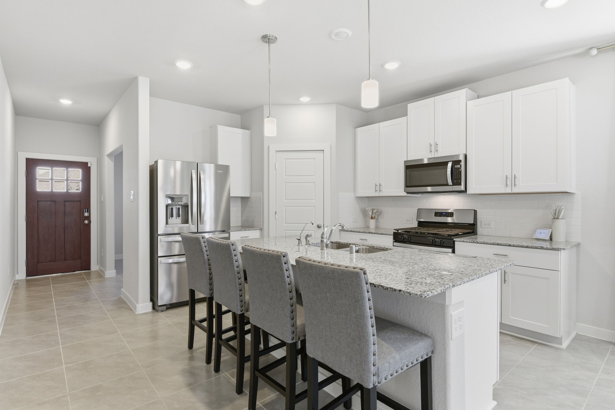 18623 Frost Ridge Drive Crosby, TX 77532 - Photo 8 of 40 a kitchen with stainless steel appliances granite countertop a refrigerator a stove a sink a dining table and chairs