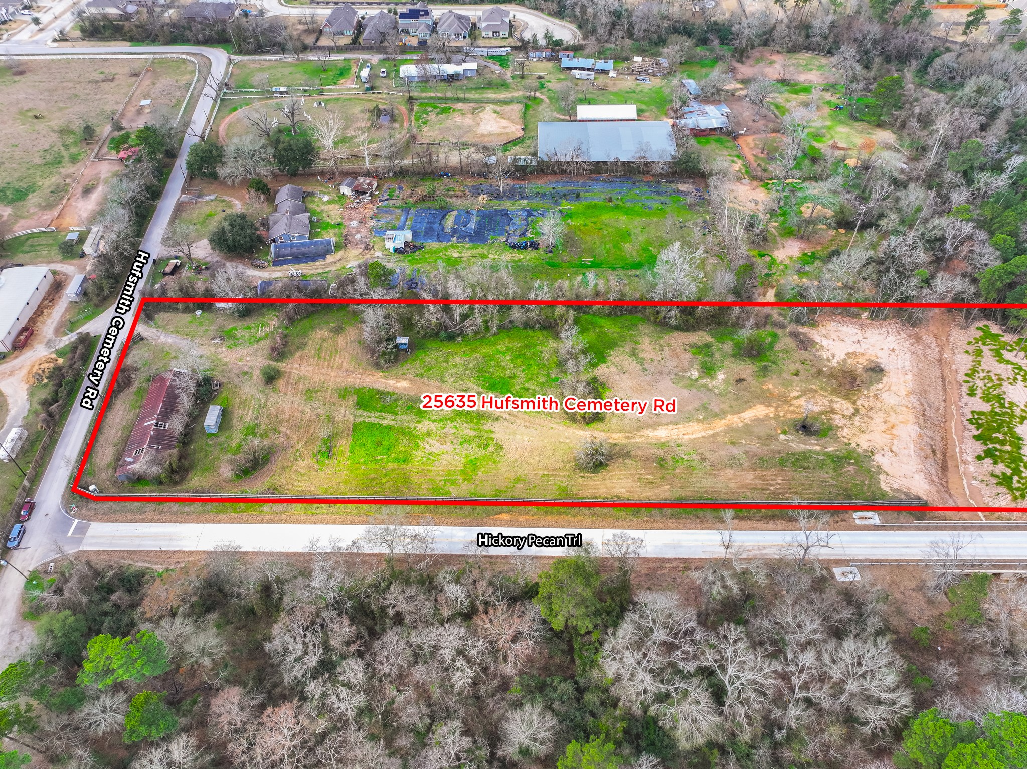 25503 Hufsmith Cemetery Road Tomball, TX 77375 - Photo 10 of 24 Another aerial perspective captures the commanding corner-lot position of this outstanding Tomball property — with the full parcel extent clearly visible, neighboring residential properties providing context, and the surrounding tree coverage creating natural boundaries that frame this remarkable land investment beautifully.