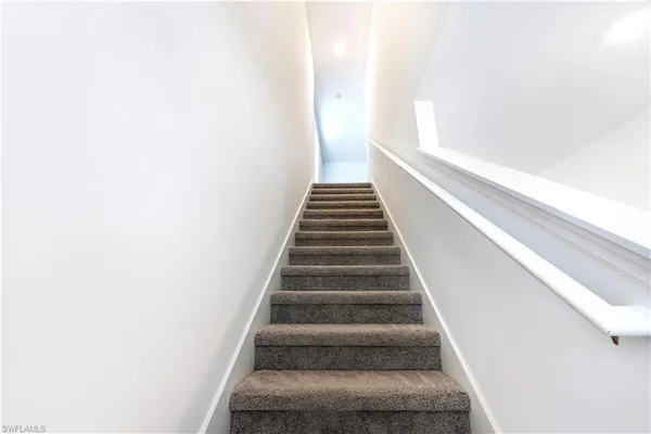 a view of a hallway with stairs