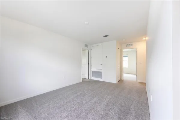 a view of an empty room and a window