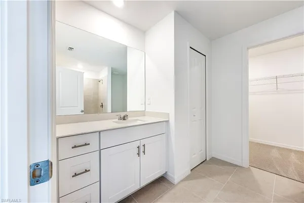 a view of an empty room with a kitchen