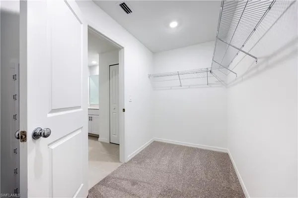 a view of a bathroom with sink mirror and window