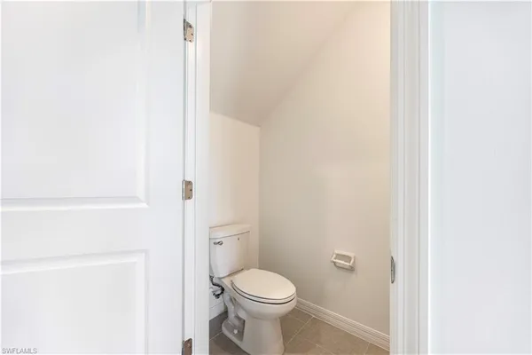 a white toilet sitting next to a shower