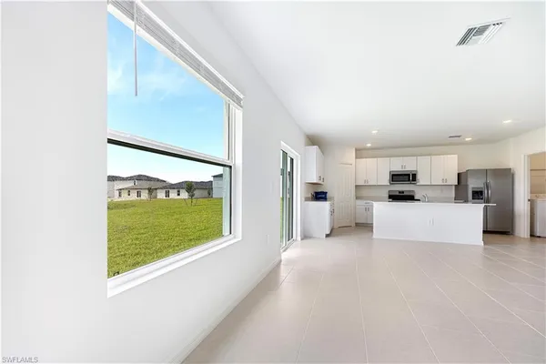 a view of kitchen with refrigerator sink and cabinets