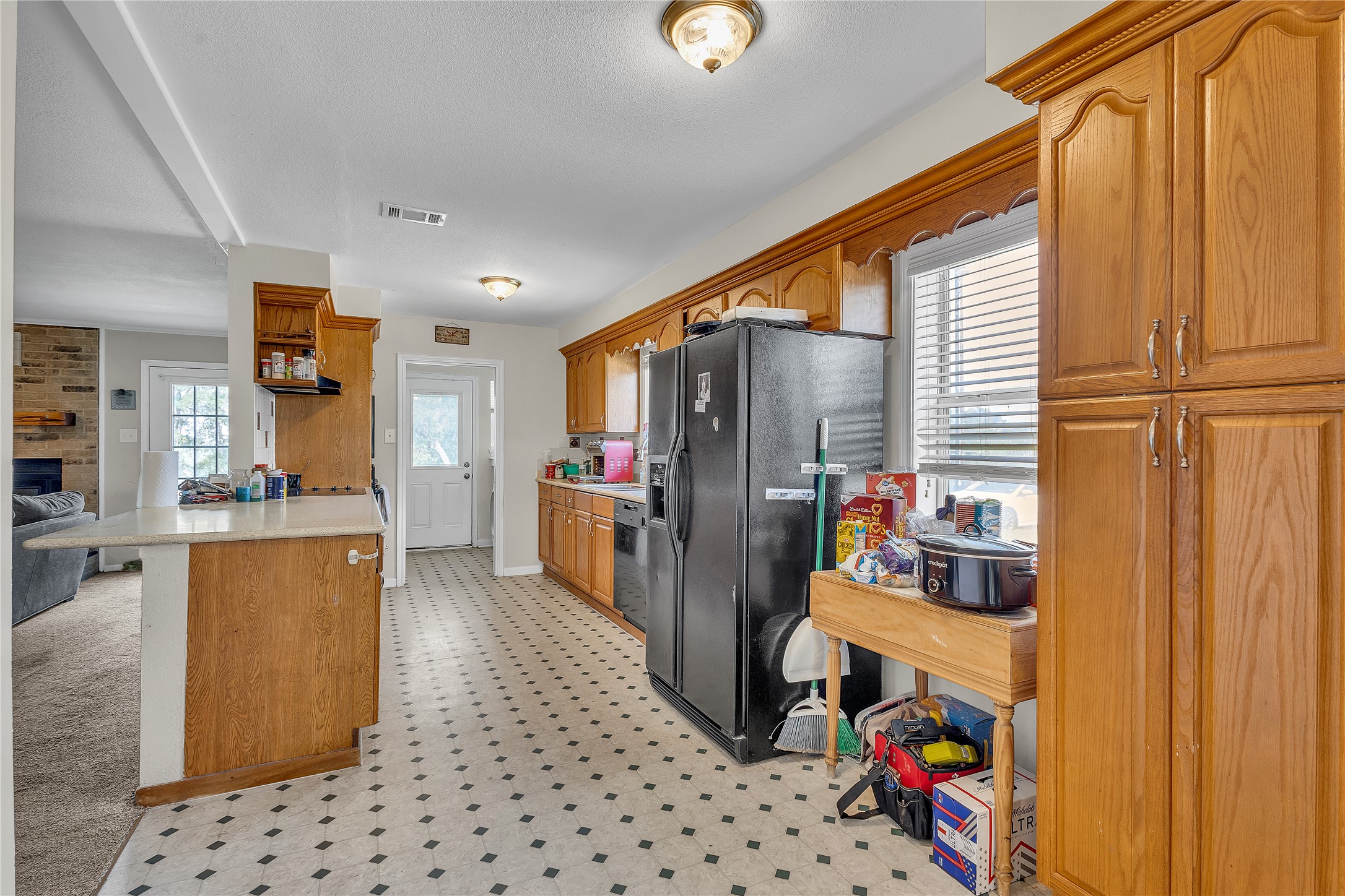 A spacious layout connects this functional kitchen to adjacent living areas.