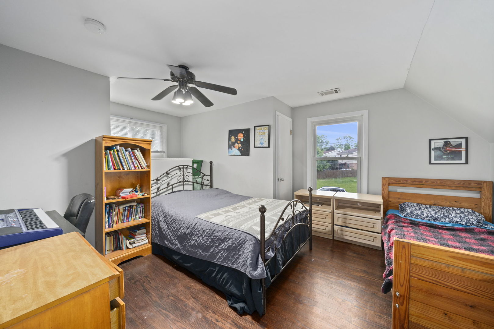 532 Willard Avenue Elgin, IL 60120 - Photo 13 of 19 a bedroom with a bed and a chandelier