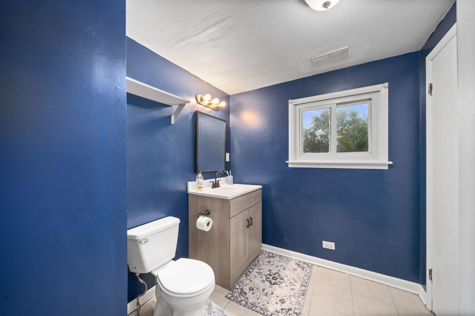 532 Willard Avenue Elgin, IL 60120 - Photo 14 of 19 a bathroom with a toilet sink and mirror