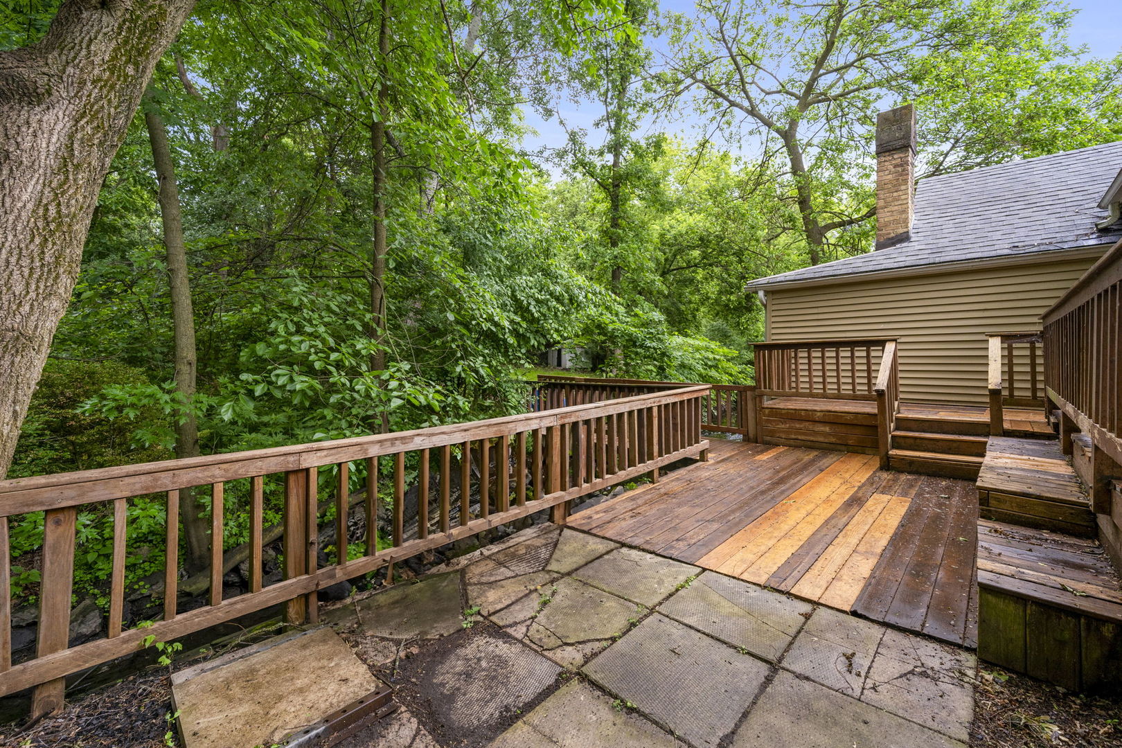 532 Willard Avenue Elgin, IL 60120 - Photo 16 of 19 a view of a wooden deck with large trees