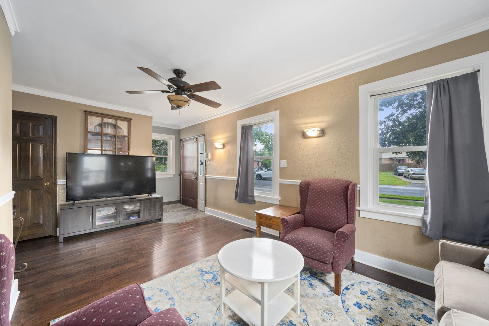 532 Willard Avenue Elgin, IL 60120 - Photo 4 of 19 a living room with furniture a flat screen tv and wooden floor