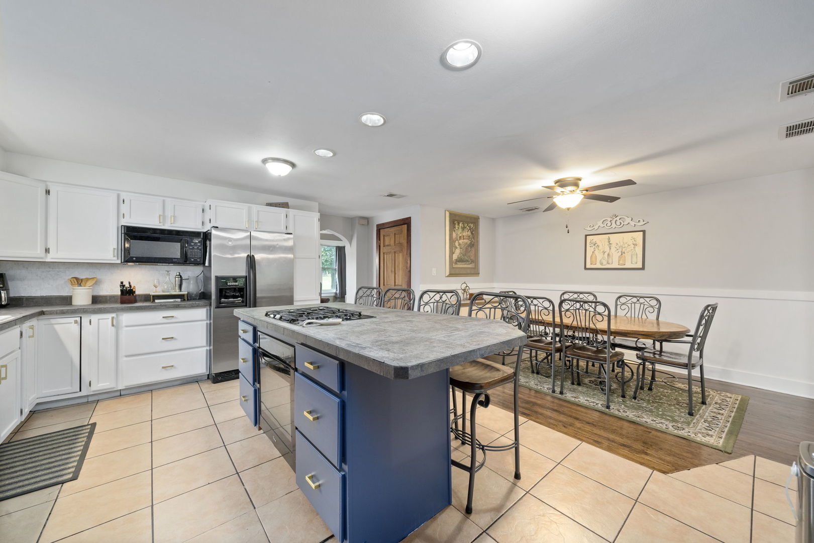 532 Willard Avenue Elgin, IL 60120 - Photo 7 of 19 a kitchen with stainless steel appliances granite countertop a stove top oven a sink a dining table and chairs