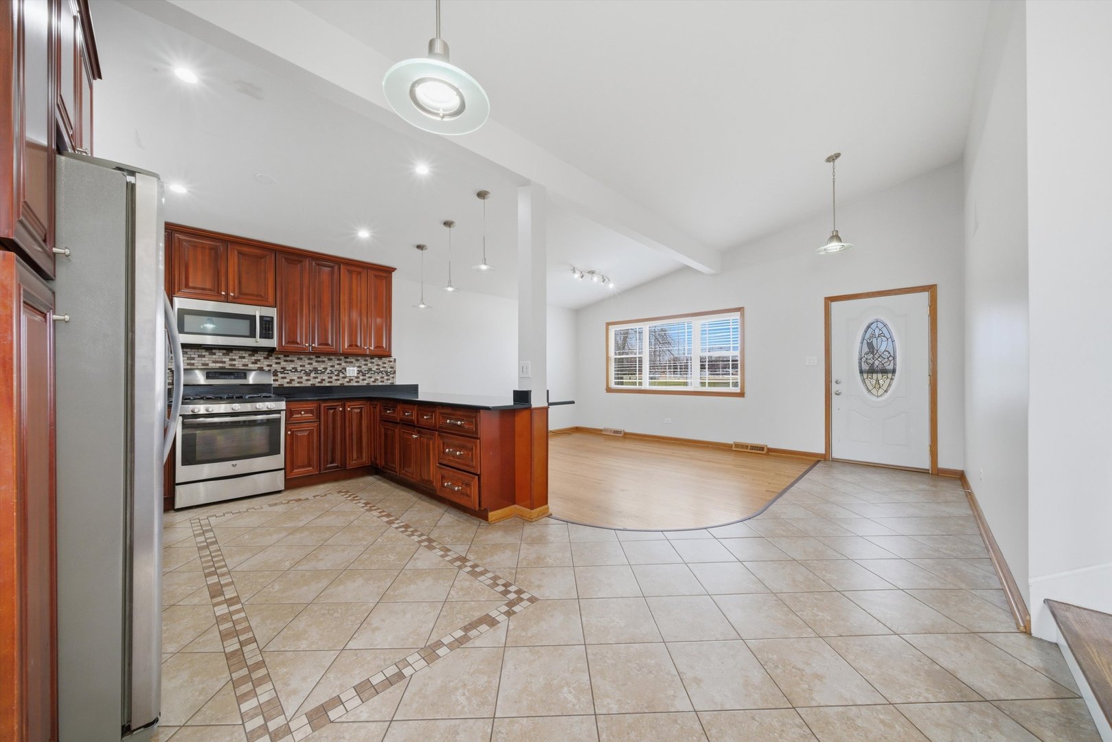 10725 Rutherford Avenue Worth, IL 60482 - Photo 13 of 44 a kitchen with stainless steel appliances granite countertop a refrigerator and a stove top oven