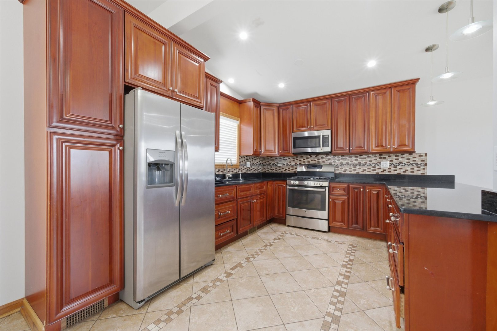 10725 Rutherford Avenue Worth, IL 60482 - Photo 14 of 44 a kitchen with stainless steel appliances granite countertop a refrigerator and a stove top oven