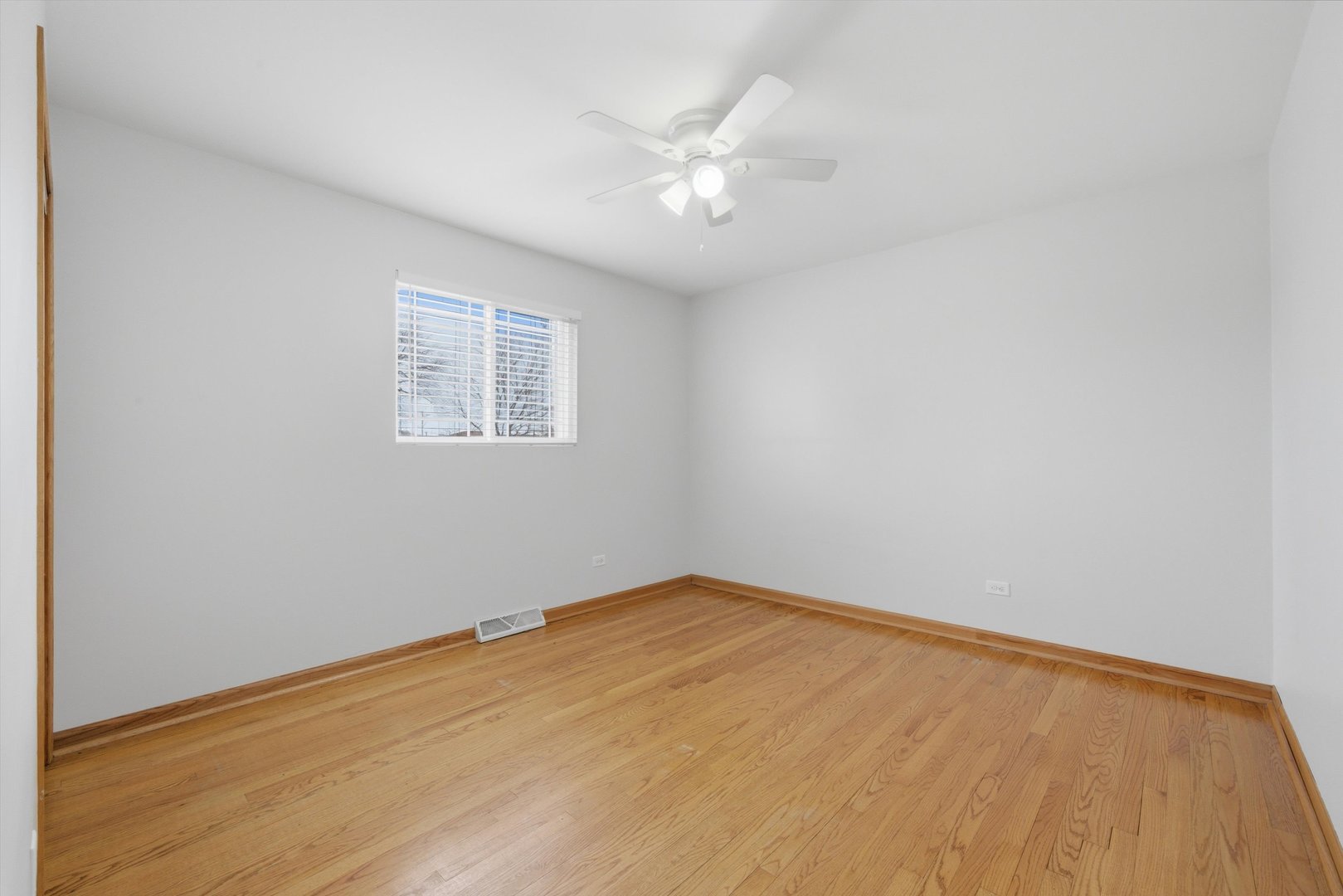 10725 Rutherford Avenue Worth, IL 60482 - Photo 24 of 44 an empty room with a chandelier fan and windows