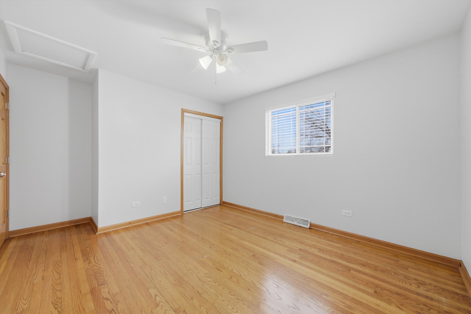 10725 Rutherford Avenue Worth, IL 60482 - Photo 25 of 44 a view of an empty room with wooden floor and a window