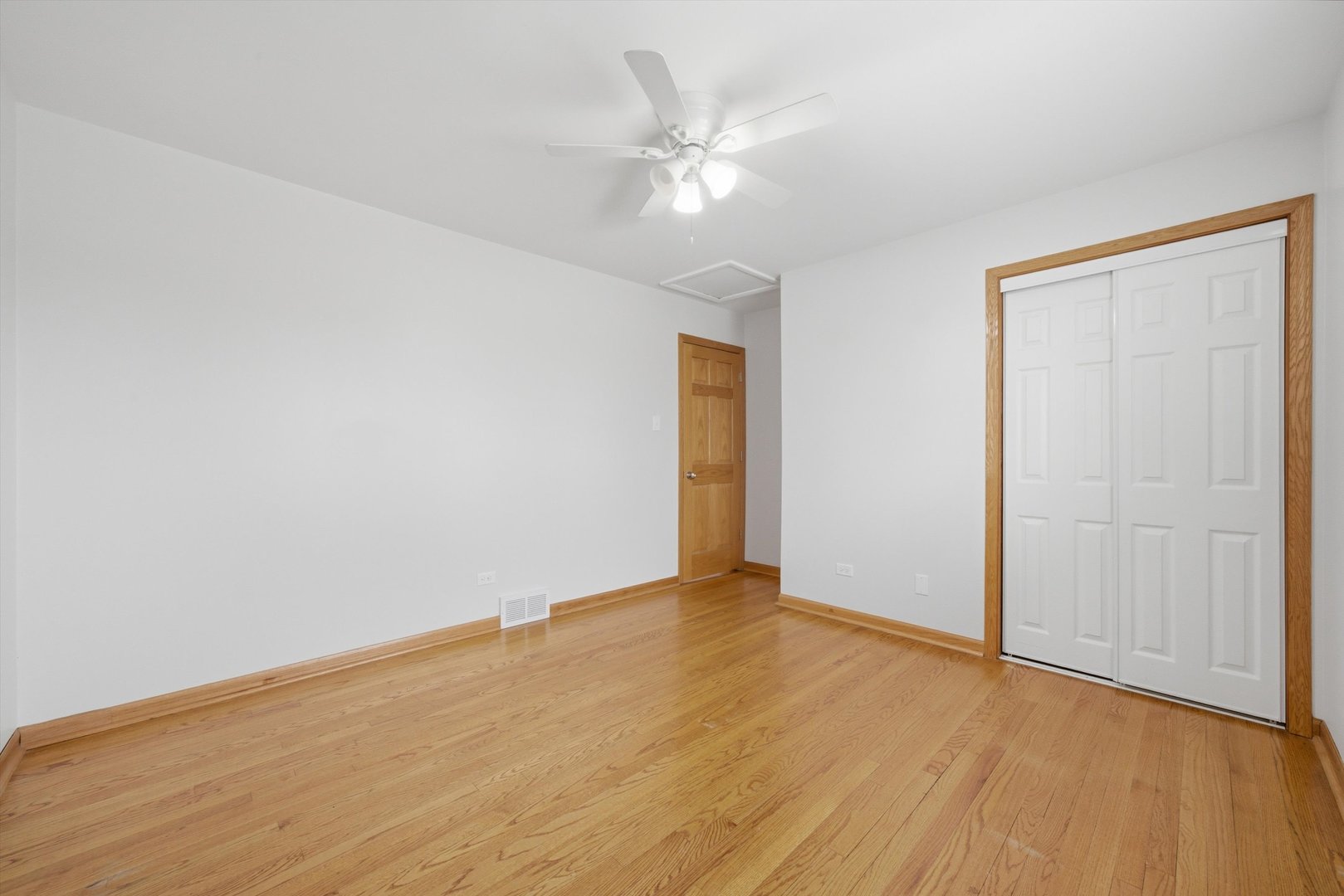 10725 Rutherford Avenue Worth, IL 60482 - Photo 26 of 44 a view of an empty room with wooden floor