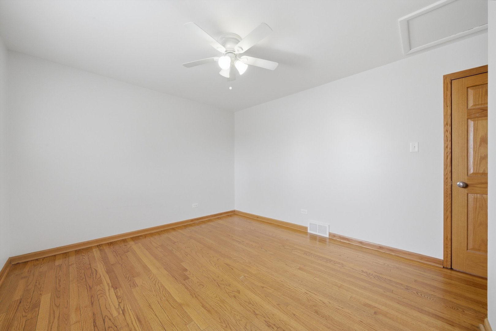 10725 Rutherford Avenue Worth, IL 60482 - Photo 27 of 44 a view of an empty room with wooden floor