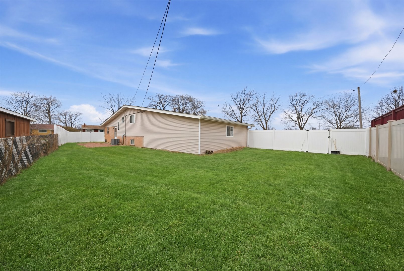 10725 Rutherford Avenue Worth, IL 60482 - Photo 5 of 44 a view of a backyard with potted plants and wooden fence