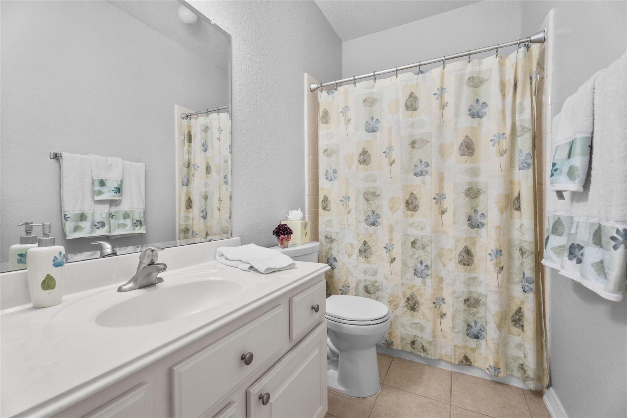 9406 Lochflora Drive Spring, TX 77379 - Photo 12 of 49 a bathroom with a sink a toilet and shower curtain