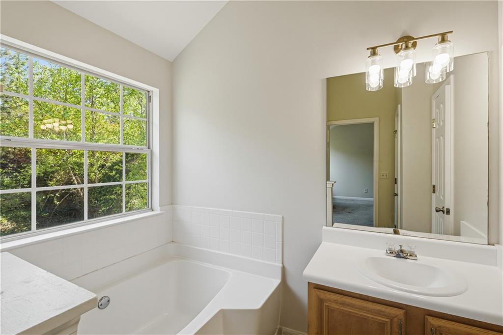 6065 Hemperly Road College Park, GA 30349 - Photo 13 of 18 a bathroom with a bath tub sitting next to a window