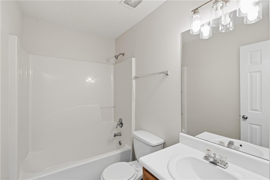 6065 Hemperly Road College Park, GA 30349 - Photo 15 of 18 a bathroom with a sink a toilet and shower