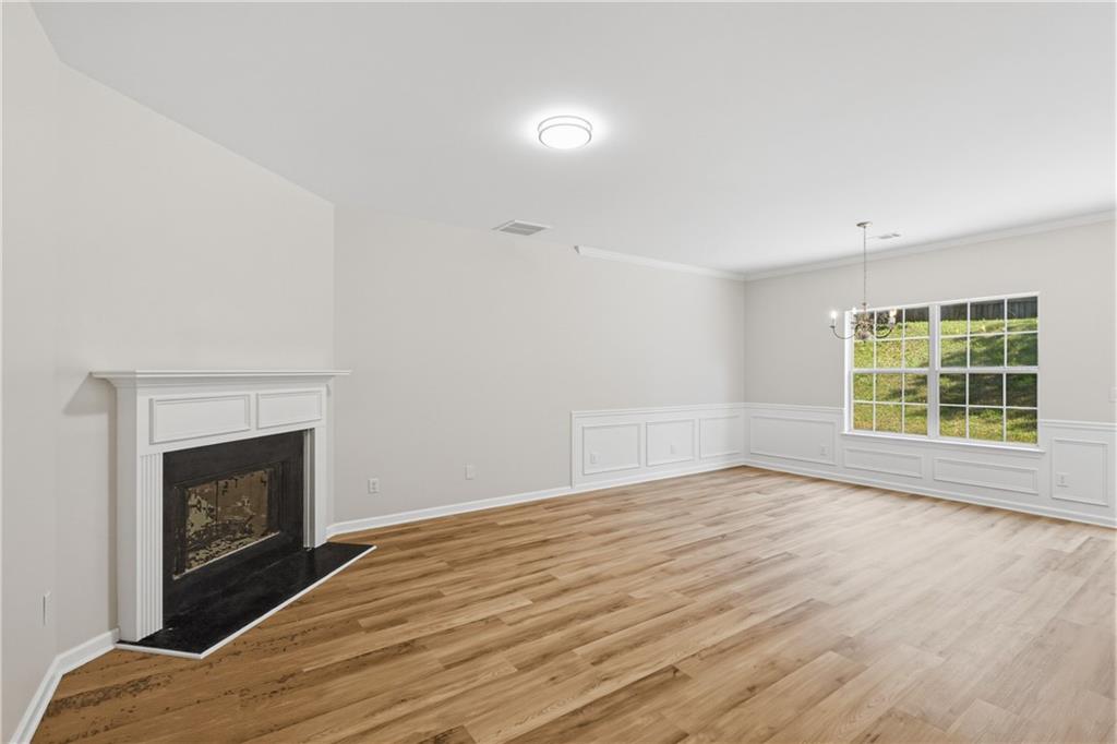 6065 Hemperly Road College Park, GA 30349 - Photo 2 of 18 a view of empty room with wooden floor and fireplace