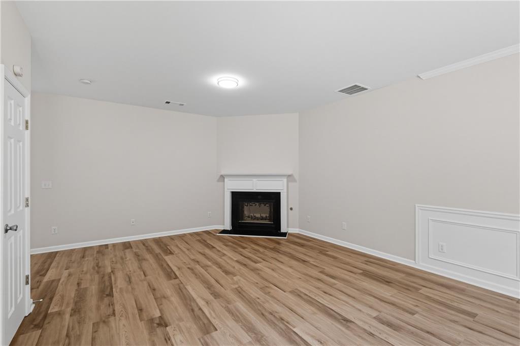 6065 Hemperly Road College Park, GA 30349 - Photo 4 of 18 a view of empty room with wooden floor and fireplace