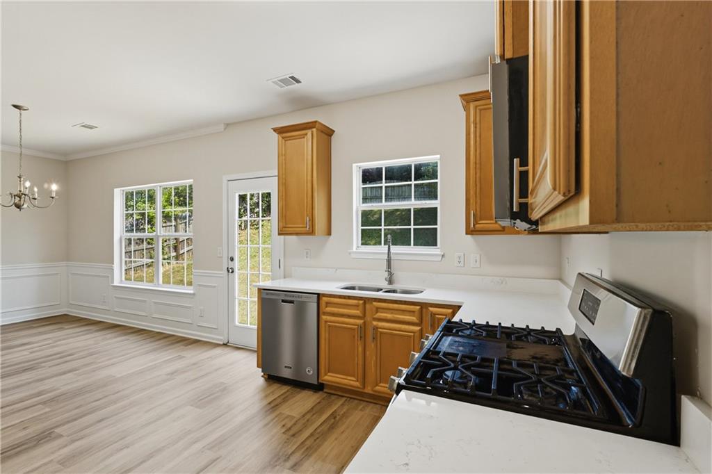 6065 Hemperly Road College Park, GA 30349 - Photo 7 of 18 a kitchen with granite countertop a stove and a sink