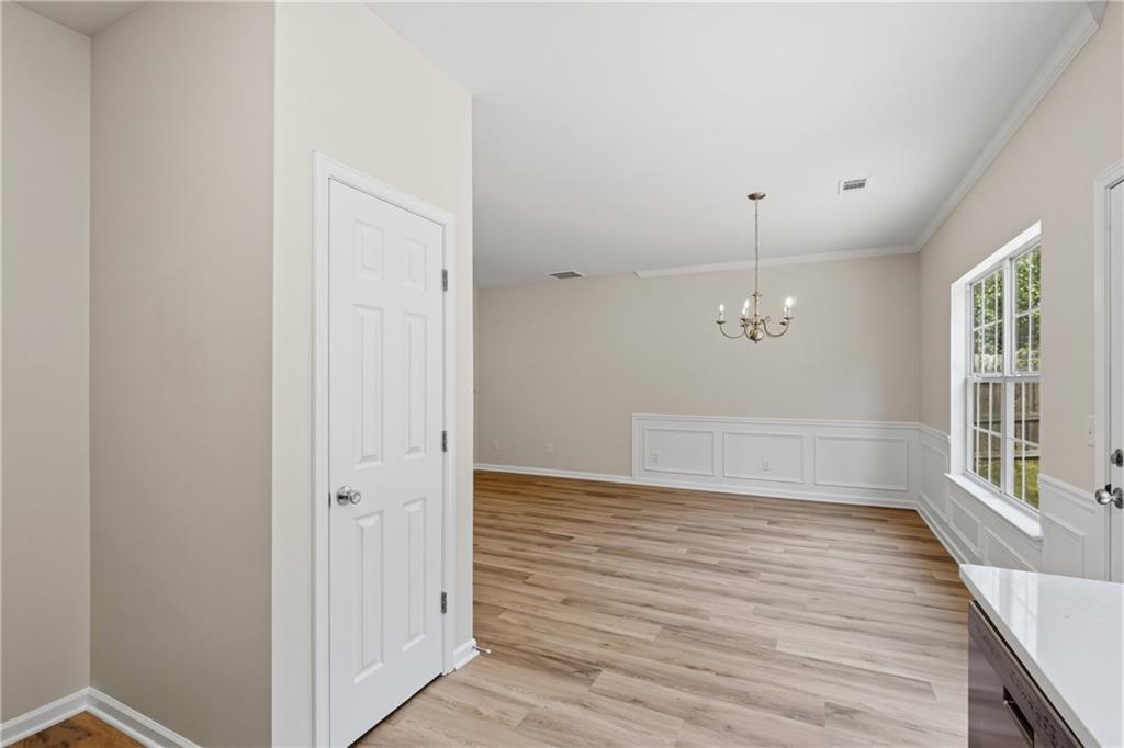 6065 Hemperly Road College Park, GA 30349 - Photo 8 of 18 wooden floor in an empty room with a window