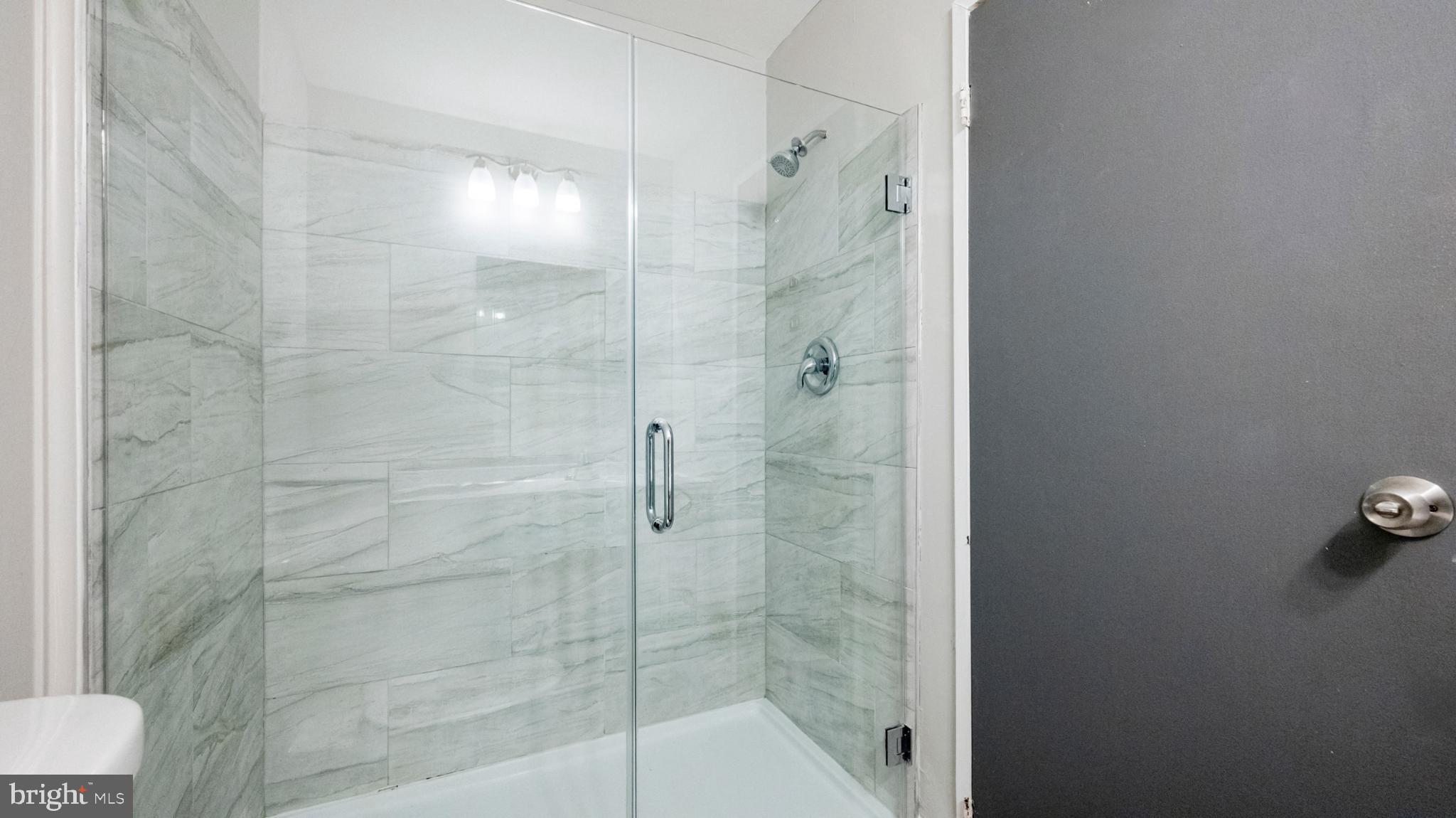 607 Bromley Estate Pine Hill, NJ 08021 - Photo 11 of 21 Sleek glass shower with elegant marble tiles.