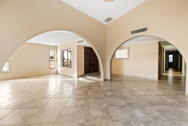 a view of an empty room with glass door
