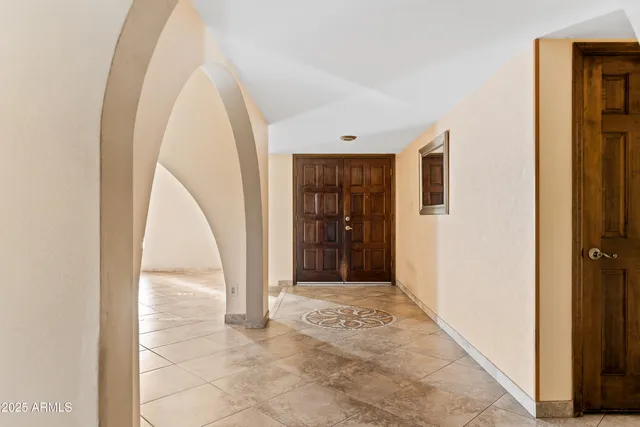 a view of a hallway with wooden floor and a bathroom