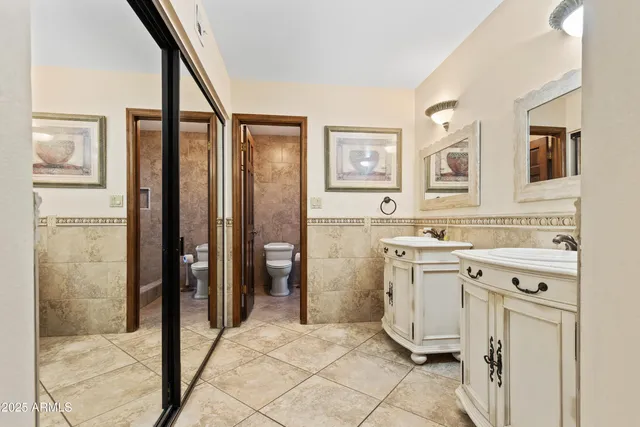 a spacious bathroom with a granite countertop sink mirror and a bathtub