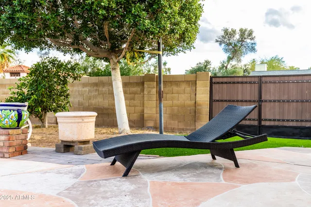 a park that has a bench and a wooden fence