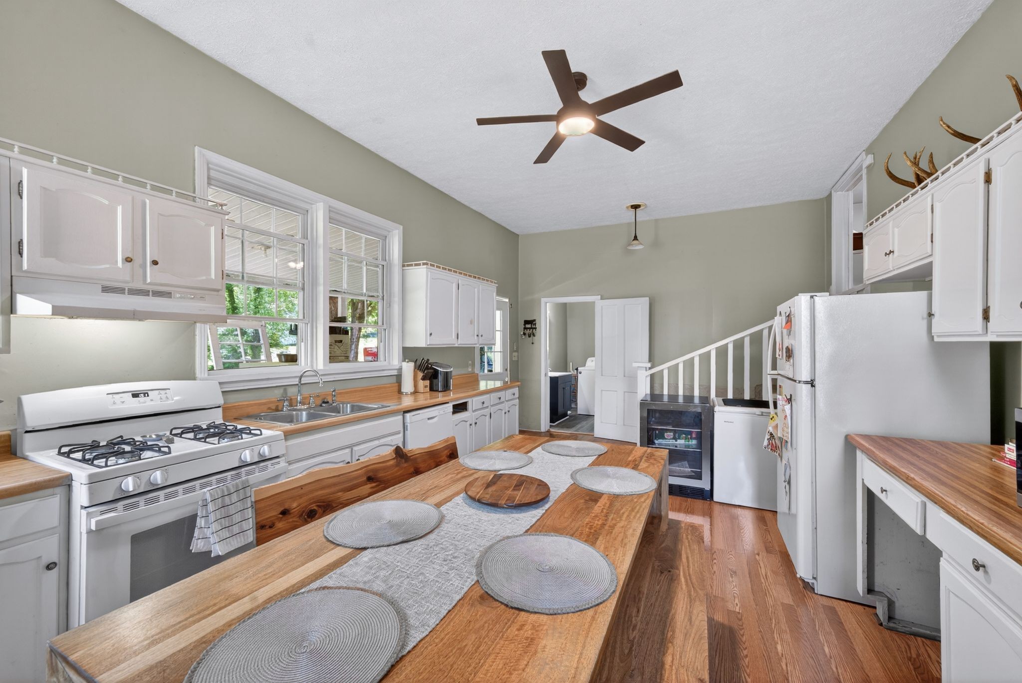 2149 Talley Road Belfast, TN 37019 - Photo 30 of 93 a kitchen with stainless steel appliances a stove a sink dishwasher a refrigerator white cabinets and wooden floor