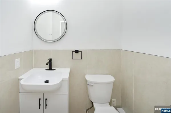 a bathroom with a sink mirror and toilet