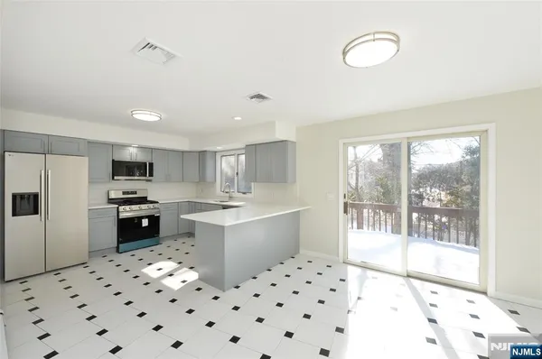 a large white kitchen with a large window