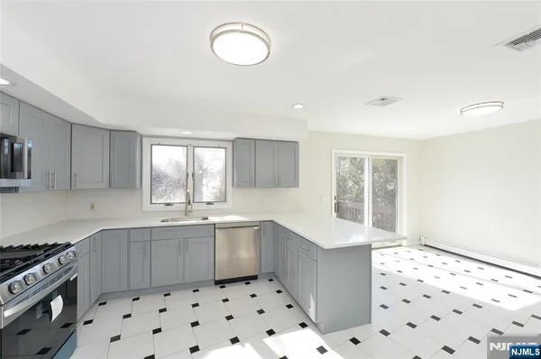 a kitchen with sink cabinets and appliances