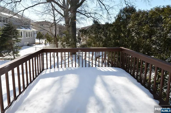 a view of balcony with wooden floor and fence