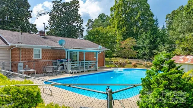 a view of house with outdoor space and swimming pool