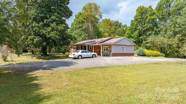 a front view of a house with a garden and swimming pool