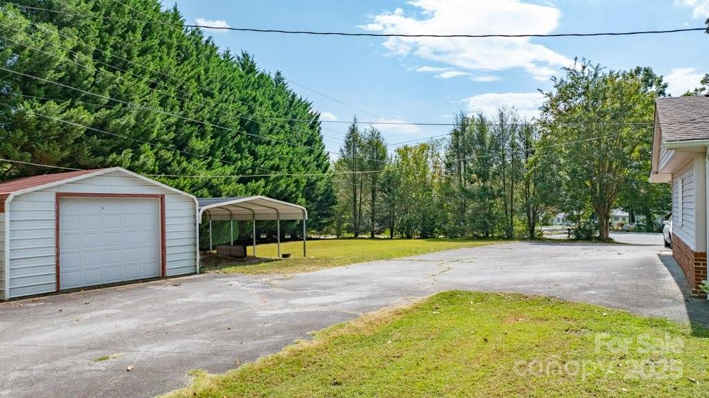 489 Ned Mcgimsey Road Nebo, NC 28761 - Photo 23 of 25 a view of a swimming pool with a yard and large tree