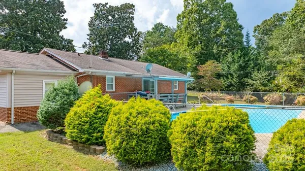 a front view of house with yard and swimming pool