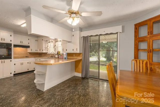 a large white kitchen with a large window
