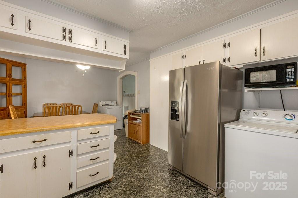 489 Ned Mcgimsey Road Nebo, NC 28761 - Photo 8 of 25 a kitchen with cabinets and stainless steel appliances