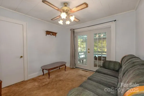 a living room with furniture and a chandelier