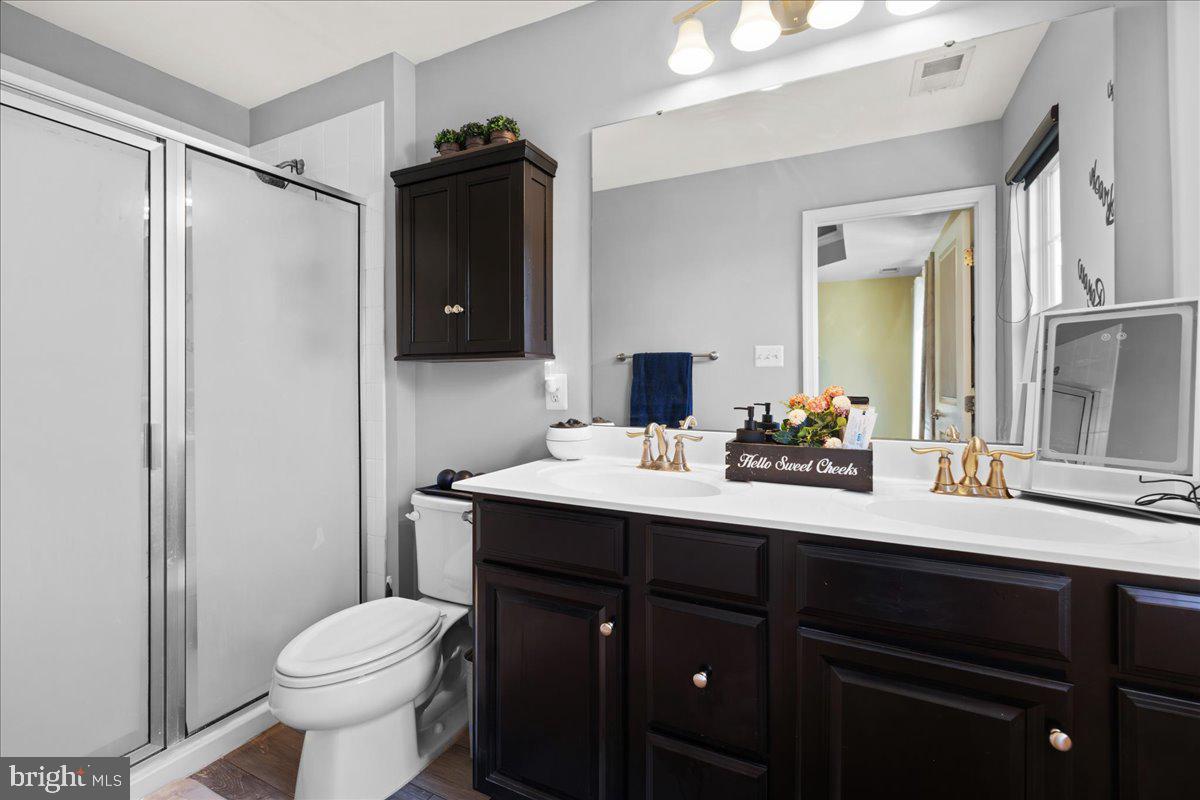 26 Quebec Court Falling Waters, WV 25419 - Photo 18 of 29 a bathroom with a sink vanity toilet and shower