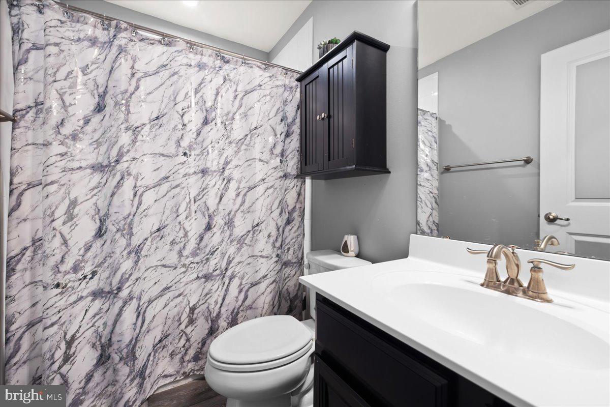 26 Quebec Court Falling Waters, WV 25419 - Photo 21 of 29 a bathroom with a sink and a toilet